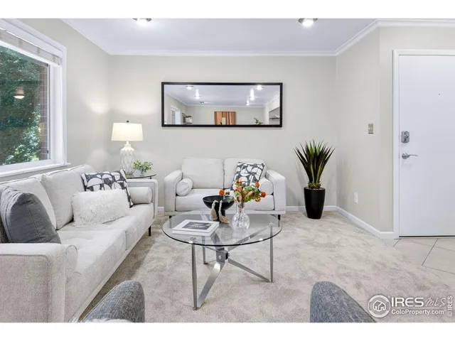 a living room with furniture and a potted plant on table