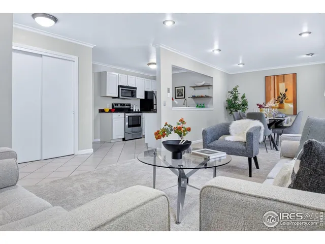 a living room with furniture and kitchen view