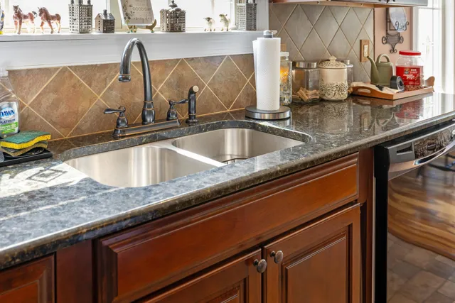 a bathroom with a double vanity sink a mirror and a bathtub