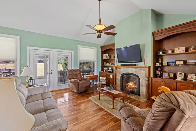 a living room with furniture a fireplace and a flat screen tv