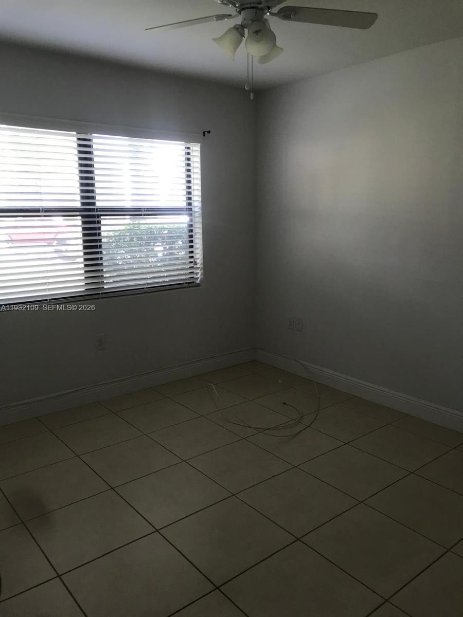 10609 Southwest 113th Place, Unit 87Z Miami, FL 33176 - Photo 14 of 21 an empty room with a window