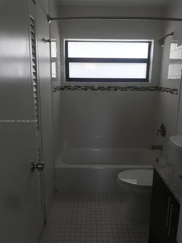 a bathroom with a toilet a sink and bath tub