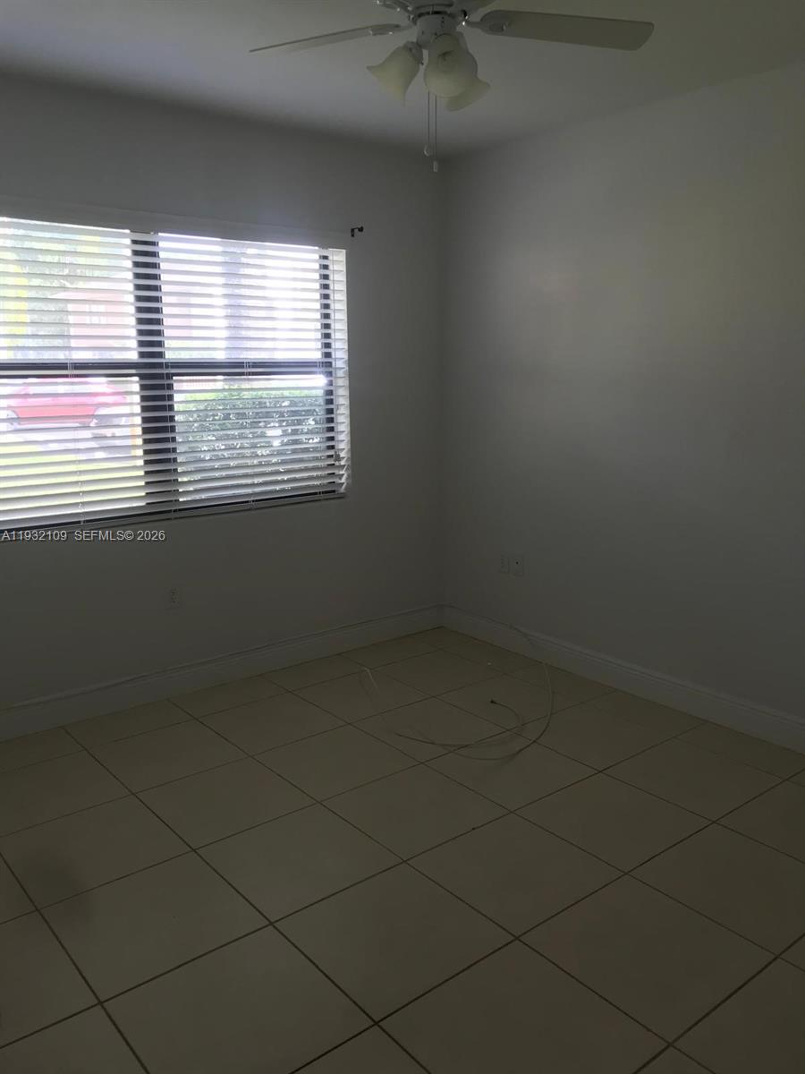 10609 Southwest 113th Place, Unit 87Z Miami, FL 33176 - Photo 19 of 21 an empty room with a window