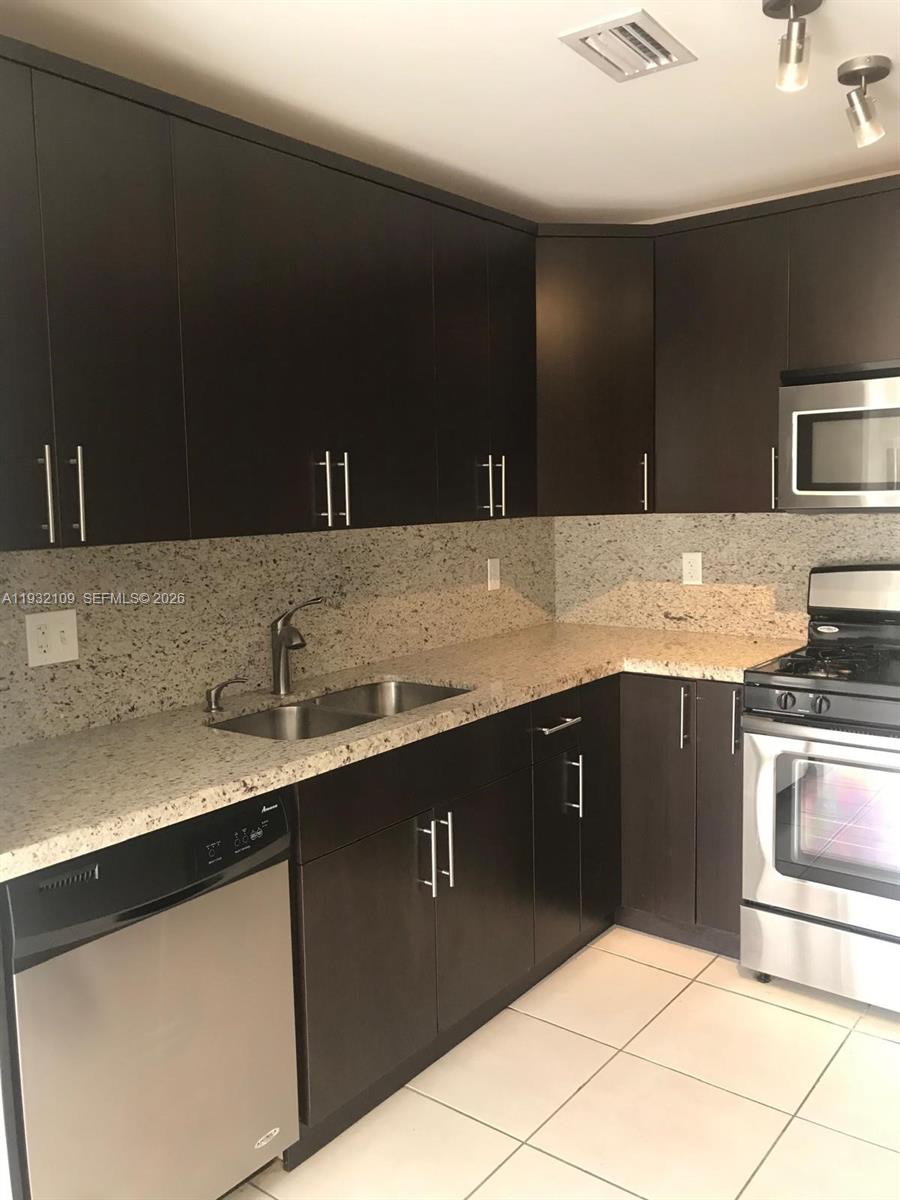 10609 Southwest 113th Place, Unit 87Z Miami, FL 33176 - Photo 5 of 21 a kitchen with a sink and cabinets
