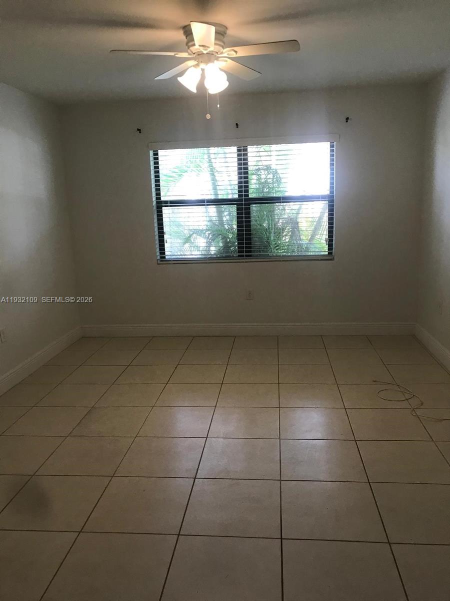 10609 Southwest 113th Place, Unit 87Z Miami, FL 33176 - Photo 9 of 21 a view of an empty room with a window