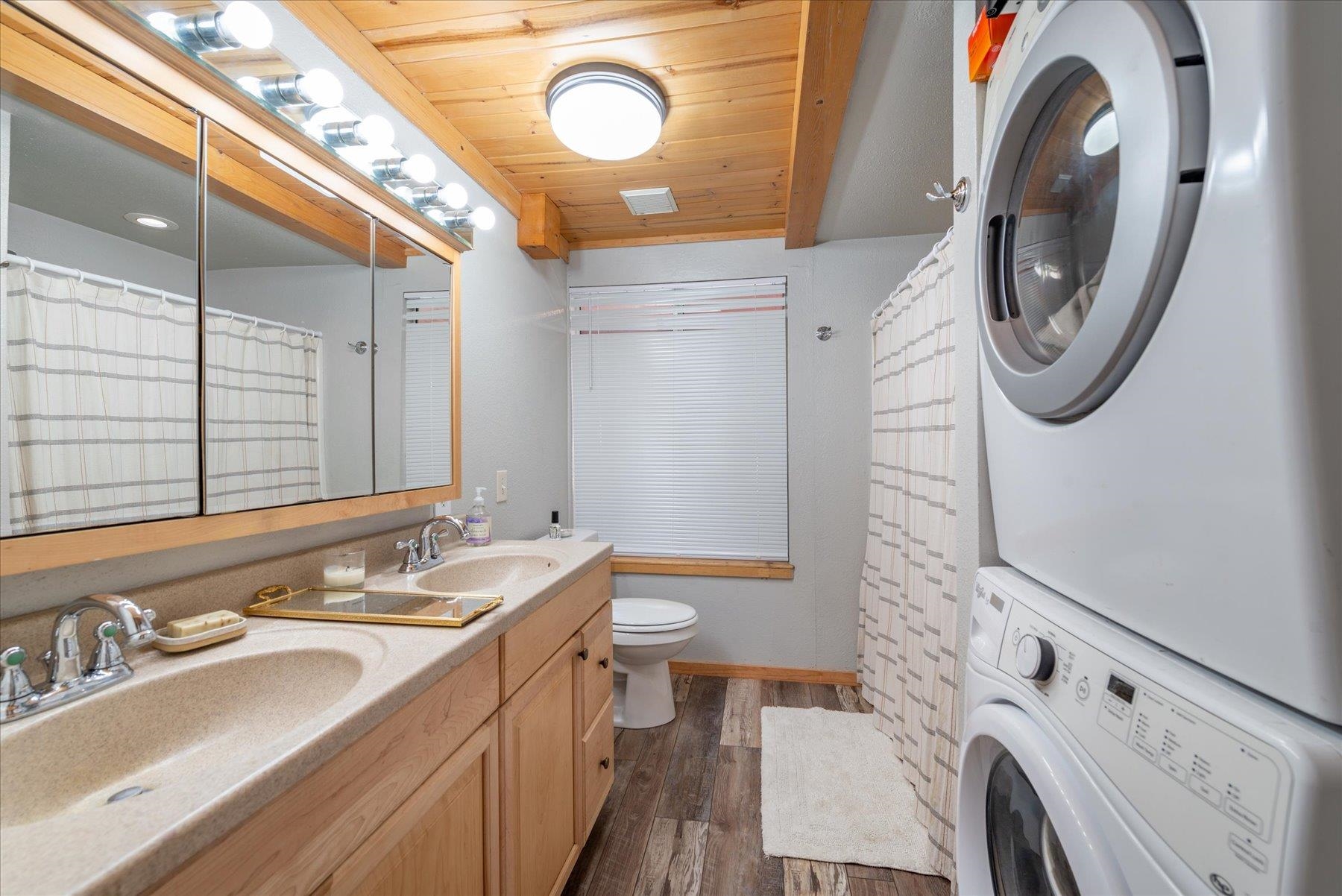 12080 Pine Forest Road Truckee, CA 96161 - Photo 14 of 20 a bathroom with a sink a toilet and a mirror