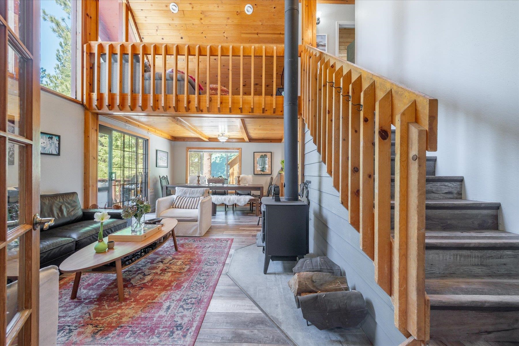 12080 Pine Forest Road Truckee, CA 96161 - Photo 8 of 20 a living room with furniture a fireplace and large windows
