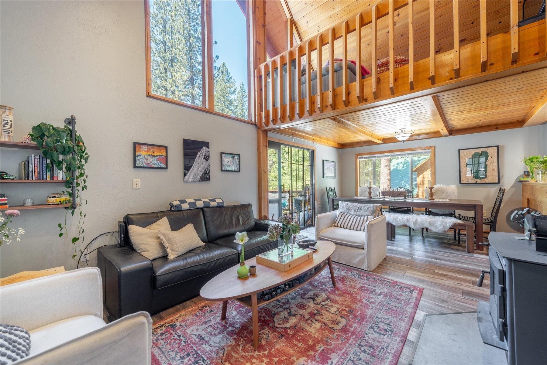 12080 Pine Forest Road Truckee, CA 96161 - Photo 9 of 20 a living room with furniture a fireplace and a large window