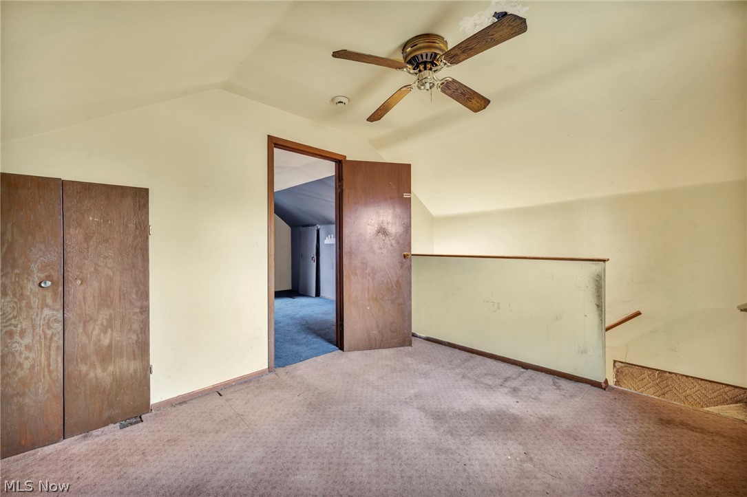 1011 Spring Road Cleveland, OH 44109 - Photo 31 of 47 Additional living space with lofted ceiling, ceiling fan, and light carpet