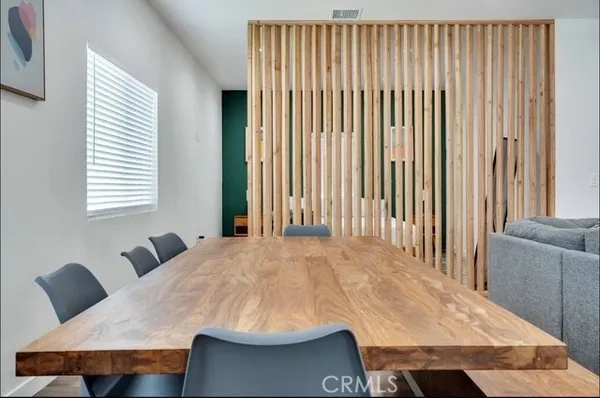 a balcony with table and chairs