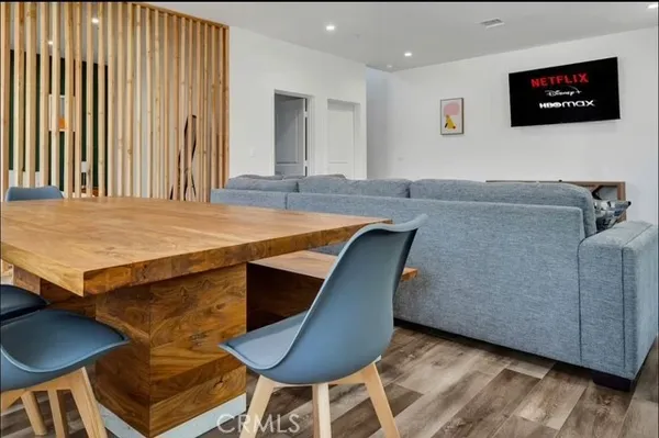a living room with a wooden floor and furniture