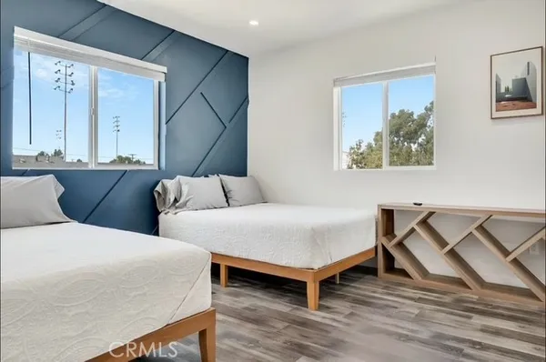 a bedroom with a bed and a painting on the wall