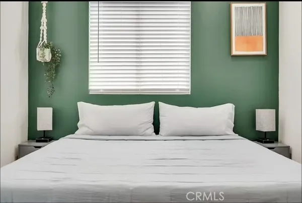 a bedroom with a bed and window