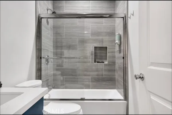 a bathroom with a shower and a toilet