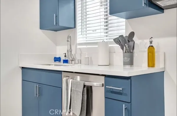 a kitchen with stainless steel appliances a sink and a window