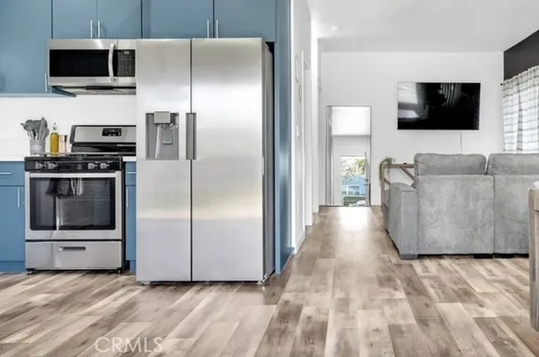 a kitchen with stainless steel appliances a refrigerator a microwave a sink and a stove