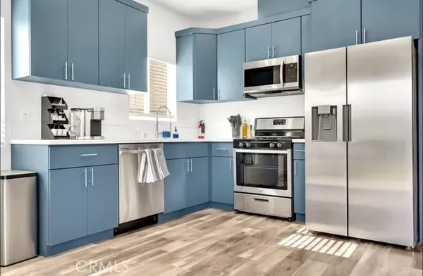 a kitchen with a refrigerator stove and microwave