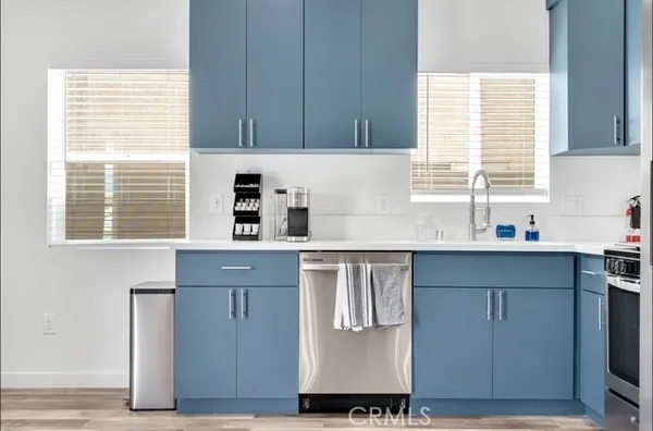 a kitchen with stainless steel appliances granite countertop a sink and a window