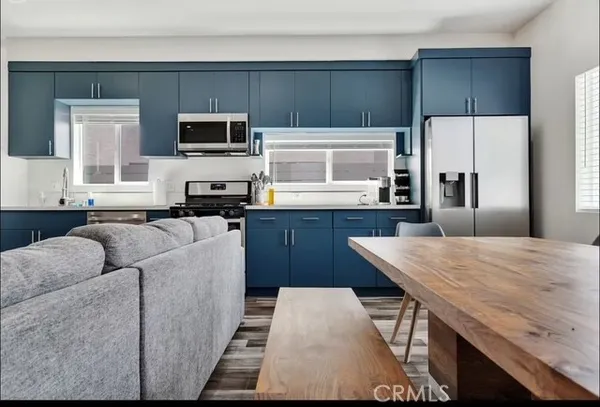 a kitchen with stainless steel appliances kitchen island granite countertop a refrigerator stove microwave and sink