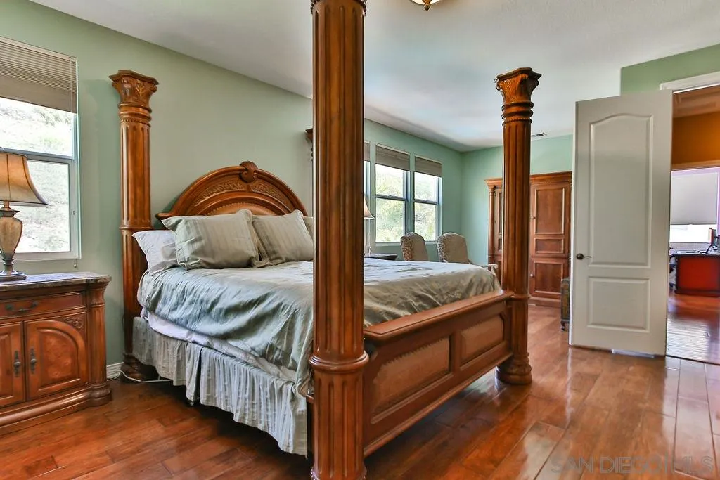 16237 Cayenne Ridge Road San Diego, CA 92127 - Photo 16 of 34 a bedroom with a bed and wooden floor