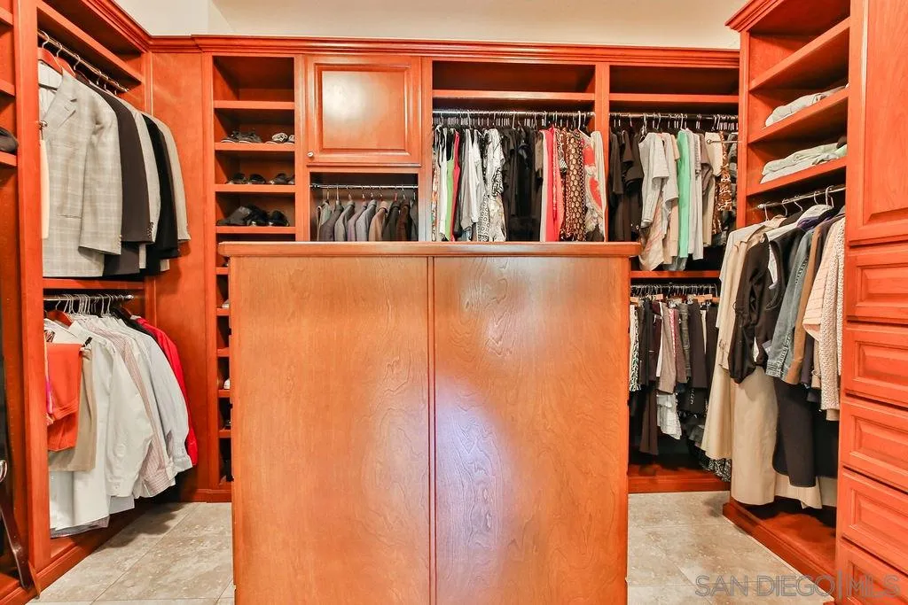 16237 Cayenne Ridge Road San Diego, CA 92127 - Photo 17 of 34 a view of walk in closet with clothes and shoes