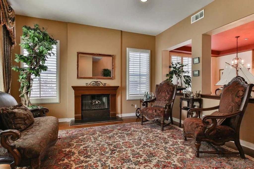 16237 Cayenne Ridge Road San Diego, CA 92127 - Photo 4 of 34 a living room with furniture a window and a fireplace