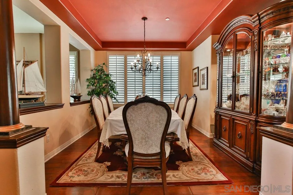 16237 Cayenne Ridge Road San Diego, CA 92127 - Photo 5 of 34 a dining room with furniture a rug and a chandelier