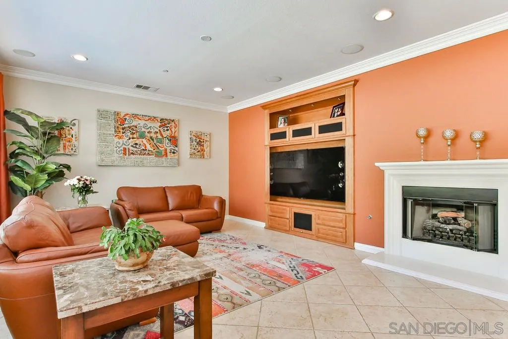 16237 Cayenne Ridge Road San Diego, CA 92127 - Photo 8 of 34 a living room with furniture a flat screen tv and a fireplace