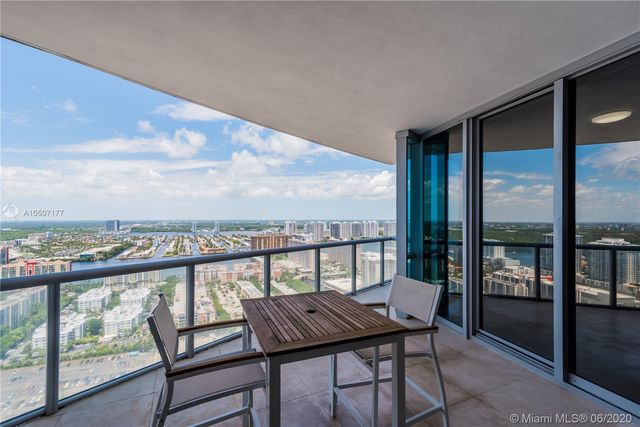a bedroom with a bed and glass door