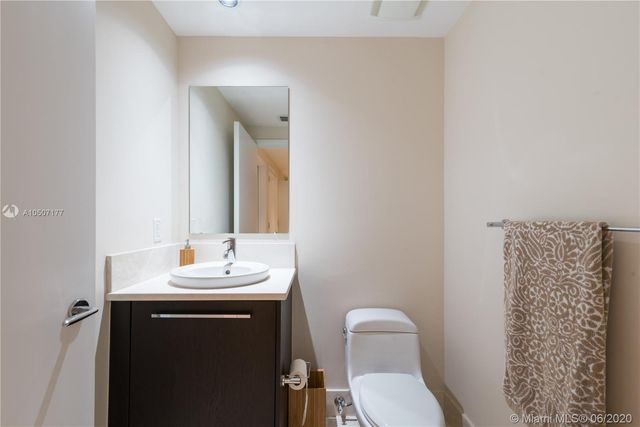 a bedroom with a bed and a view of kitchen