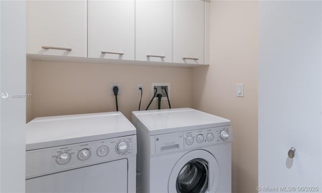 a bedroom with furniture and a large window
