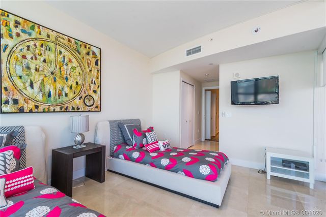 a kitchen with stainless steel appliances a sink a stove a microwave a refrigerator a stove and cabinets