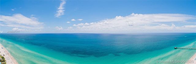 a view of a hallway with seating area