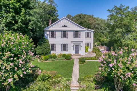 a view of a house with yard and a garden