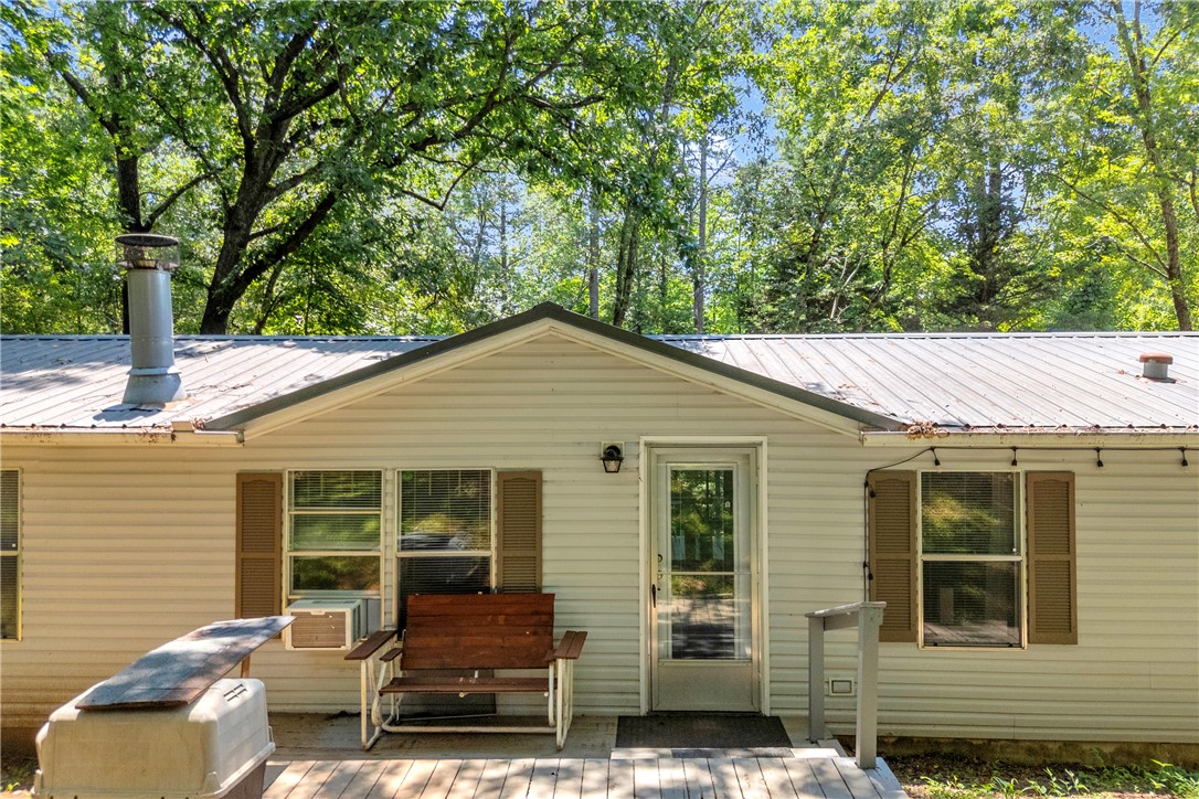 162 Newberry Road Walhalla, SC 29691 - Photo 45 of 50 A charming exterior welcomes with a spacious porch and verdant forest backdrop.