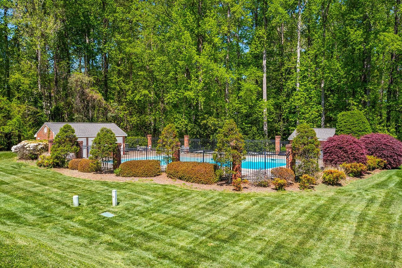 2315 Upper Oaks Way Raleigh, NC 27615 - Photo 42 of 45 Neighborhood Pool framed in Lush Landscaping