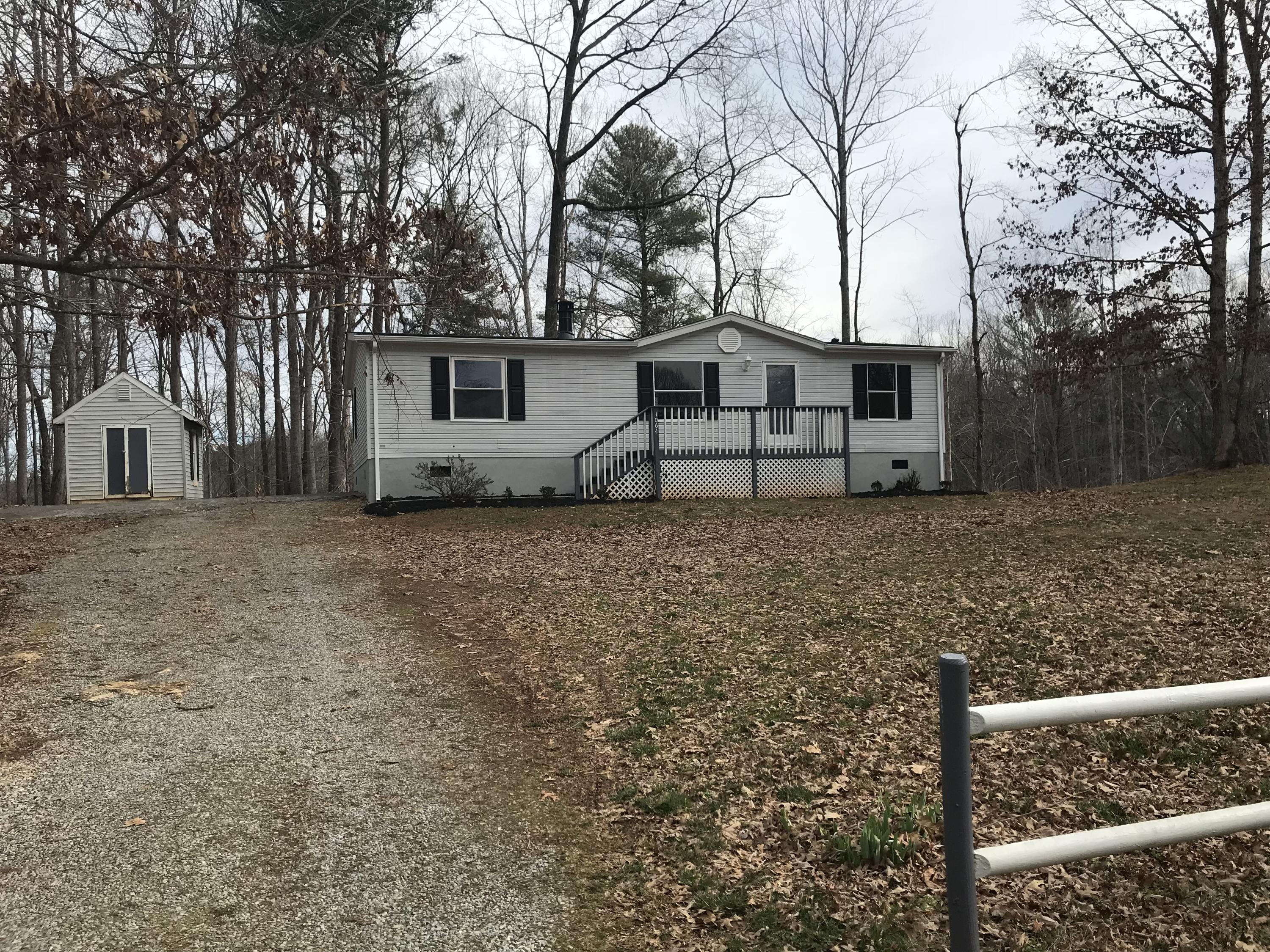 1064 Old Plantation Road Goodview, VA 24095 - Photo 1 of 10 a house that has a tree in front of it