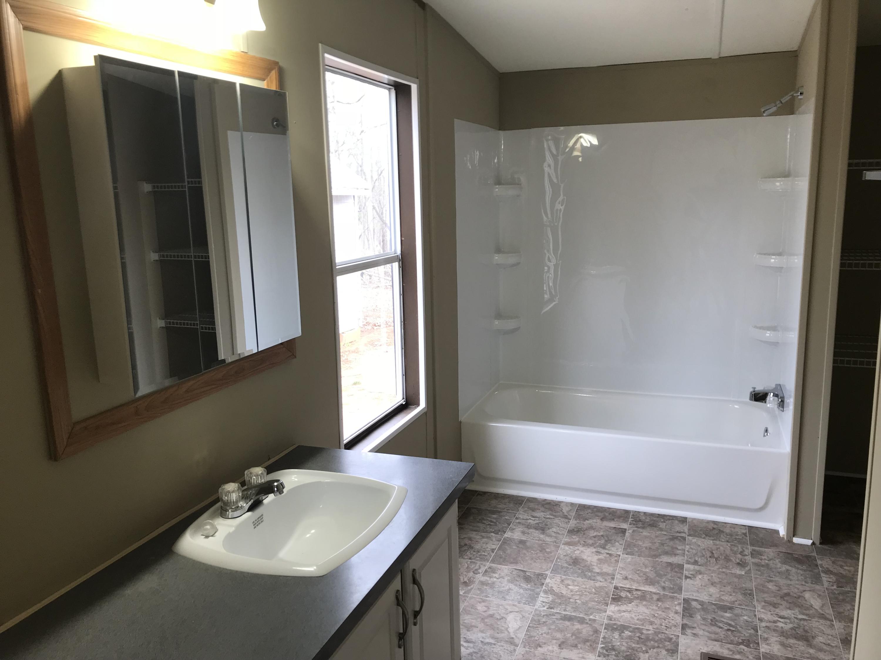 1064 Old Plantation Road Goodview, VA 24095 - Photo 10 of 10 a bathroom with a sink mirror toilet and bathtub