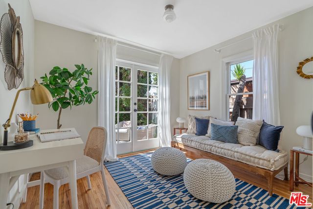 a living room with furniture a rug and a walk in closet