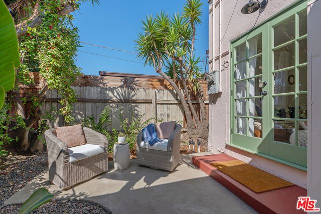a view of house with patio outdoor seating and plants