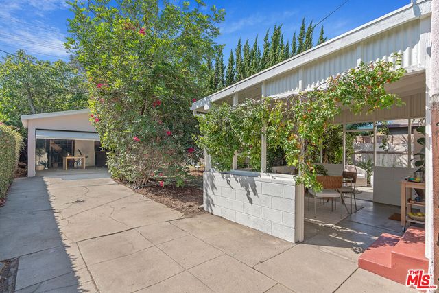 a view of backyard with outdoor seating and trees