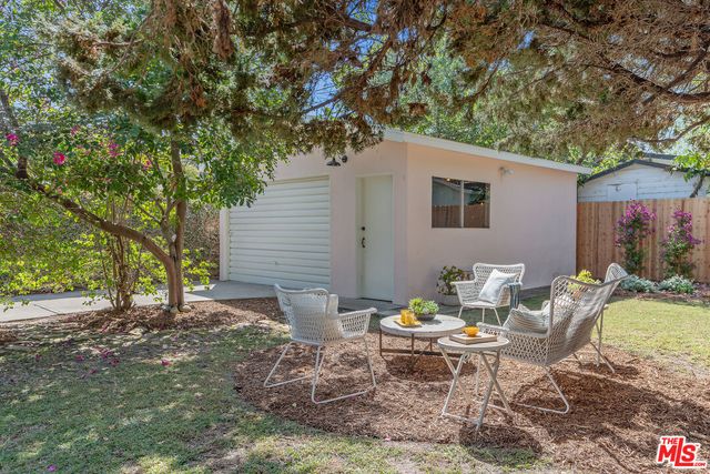 a view of a chairs and table in the patio