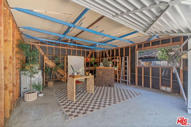 a view of a chairs and table in backyard