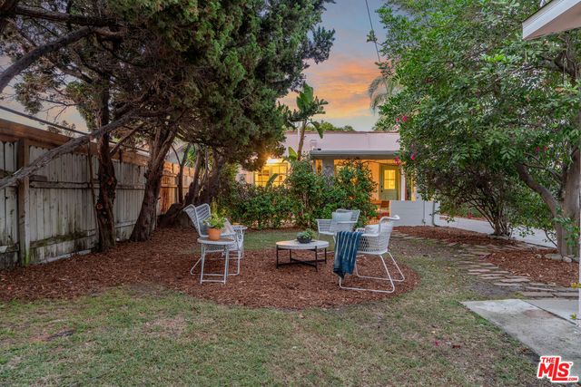 a view of a patio with table and chairs and potted plants