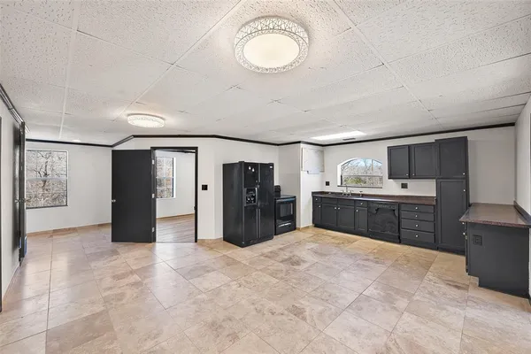 a kitchen with a refrigerator and a sink