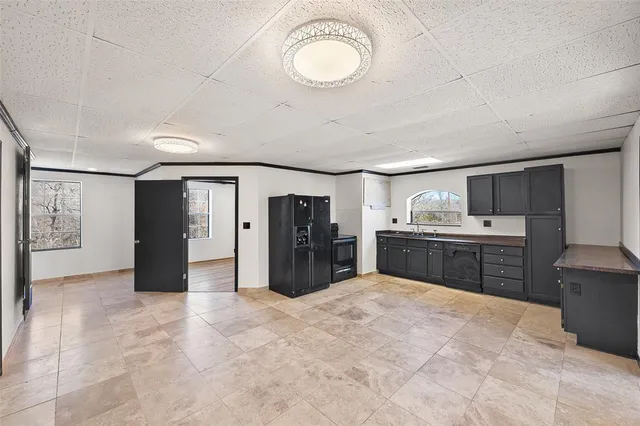 a kitchen with a refrigerator and a sink
