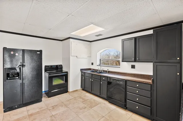 a kitchen with stainless steel appliances granite countertop a refrigerator and a stove