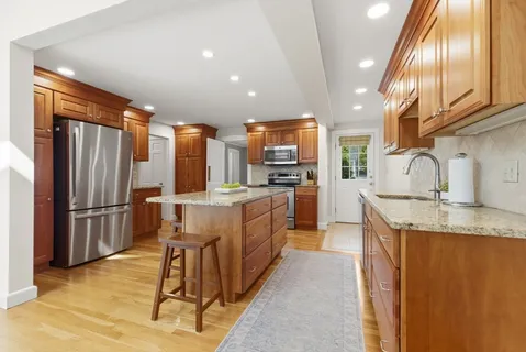 a kitchen with refrigerator and cabinets