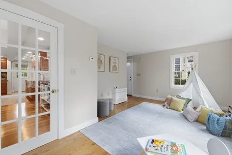 a bedroom with furniture and a wooden floor