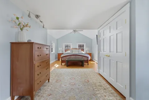 a bedroom with bed and dresser